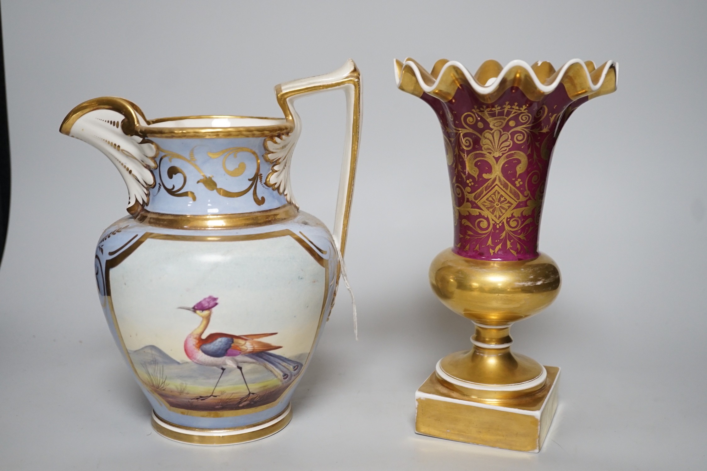 An H & R Daniel jug decorated with exotic birds 22cms high and a floral decorated trumpet vase, pattern no. 1040, 22cm